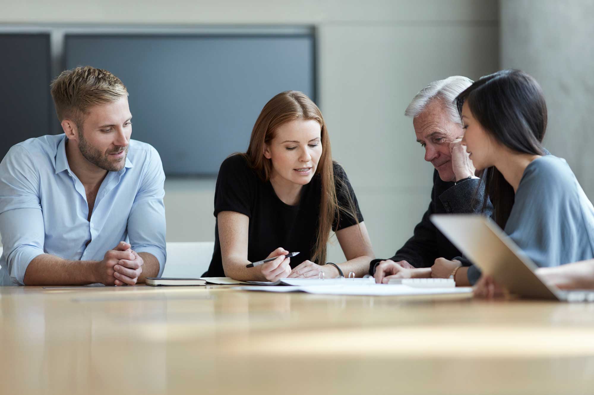 business-people-reviewing-paperwork-in-meeting