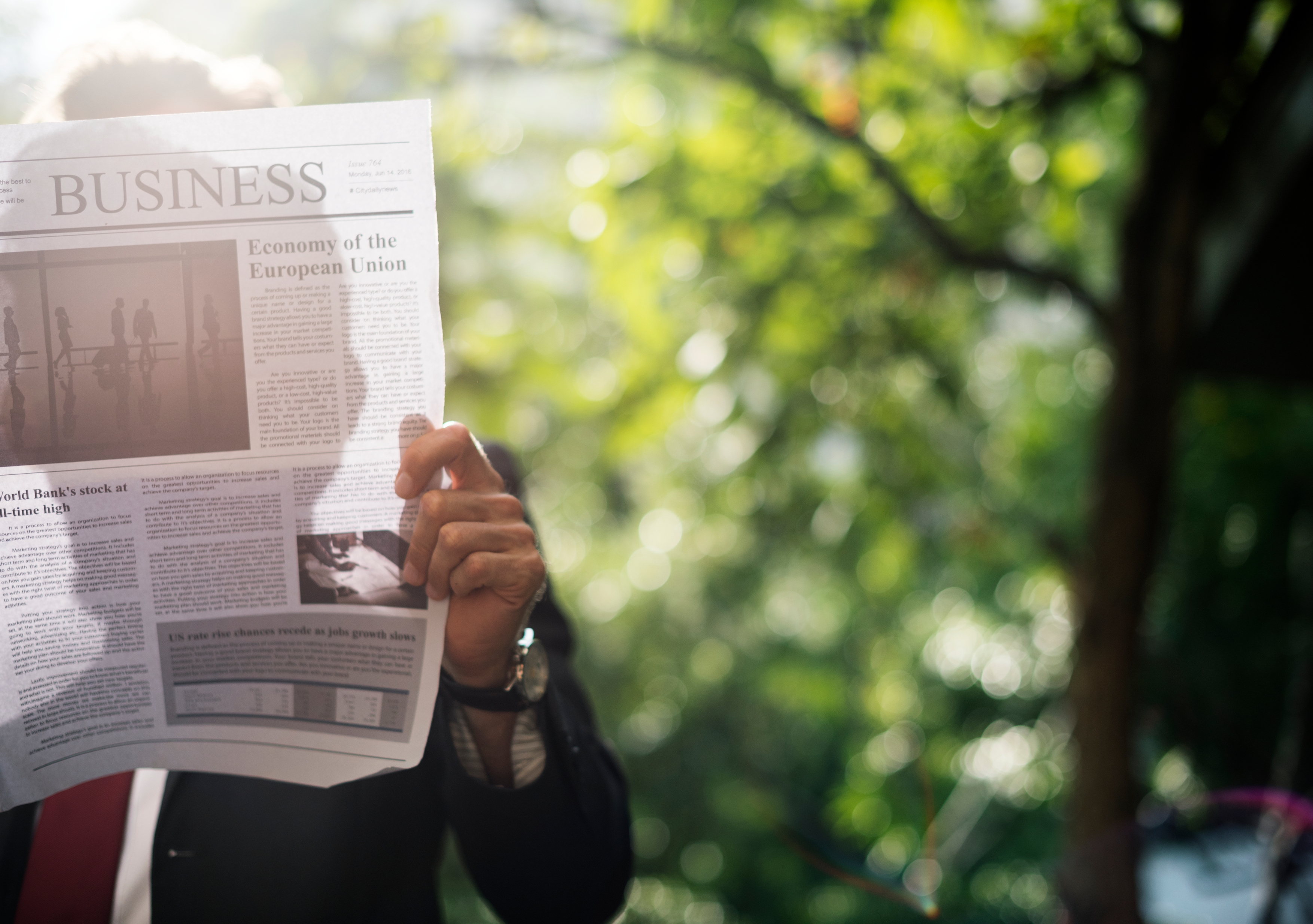 businessman_standing_and_reading_newspaper